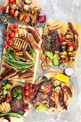Assorted delicious grilled meat with vegetable on rustic table