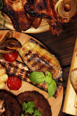 Assorted delicious grilled meat with vegetable on rustic table