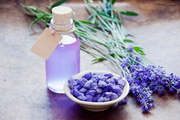 Obraz na płótnie Canvas Aromatherapy oil and lavender, lavender spa, Wellness with lavender, lavender Scented stones lavender syrup on a wooden background