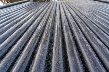 Offshore Industry oil and gas production petroleum pipeline. Downhole drilling rig. Laying the pipe on the deck. View of the shell of drill pipes laid in courtyard of the oil and gas warehouse.