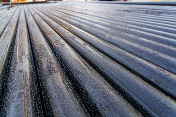 Obraz premium Offshore Industry oil and gas production petroleum pipeline. Downhole drilling rig. Laying the pipe on the deck. View of the shell of drill pipes laid in courtyard of the oil and gas warehouse.