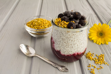 Pudding with chia,black currant  and  bee pollen on the grey  wooden background