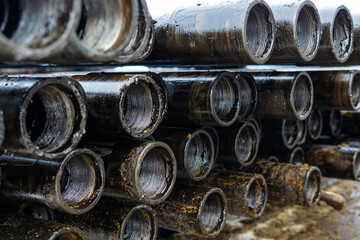 Offshore Industry oil and gas production petroleum pipeline. Downhole drilling rig. Laying the pipe on the deck. View of the shell of drill pipes laid in courtyard of the oil and gas warehouse.