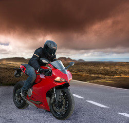 red Biker on a volcanic landscape