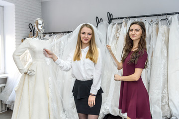 Young bride posing with veil in wedding salon