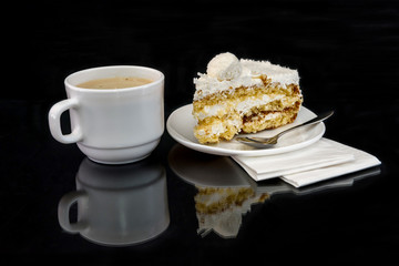 Piece of tasty cake and coffee with reflection