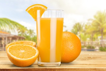 Orange juice and slices of orange on background