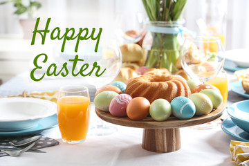 Text Happy Easter and delicious cake with painted eggs on table