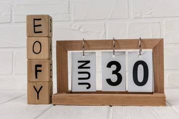 Wooden calendar with cubes and text 'EOFY' on it