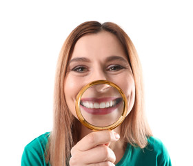 Smiling woman with perfect teeth and magnifier on white background