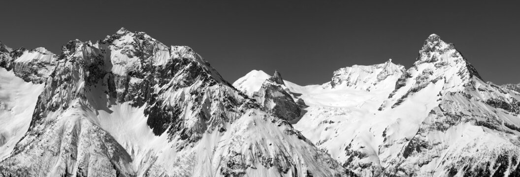 Black and white panorama of snowy covered mountain peaks