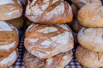 Stacks of rustic sourdough bread on table, close up