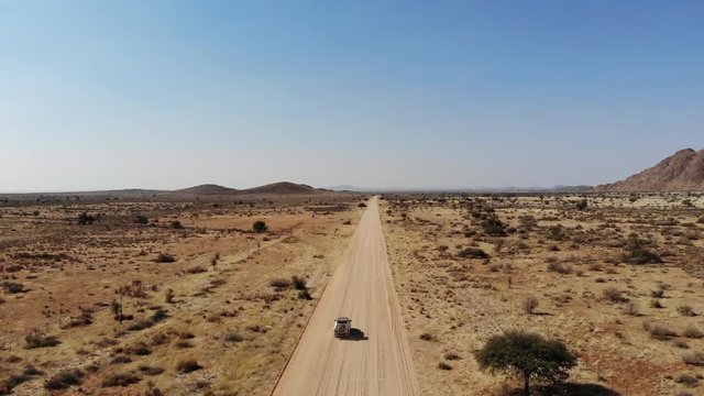 4x4 offroad vehicle driving on dirt track in Khomas Highland, close to Gamsberg and Spreetshoogte Pass, Namibia, Aerial drone shot