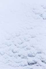 Fototapeta na wymiar Close-up of fresh built up snow, good as a winter season background or texture. A slight blue hue.