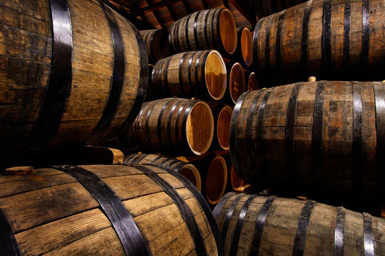 Rows of alcoholic drums in stock. Distillery. Cognac, whiskey, wine, brandy. Alcohol in barrels