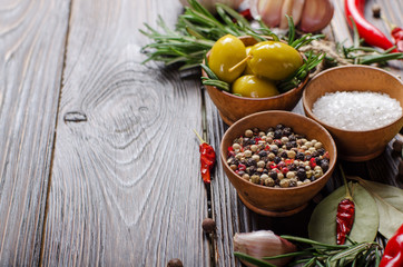 Food background frame made of oils condiments and spices on kitchen table. Cooking concept