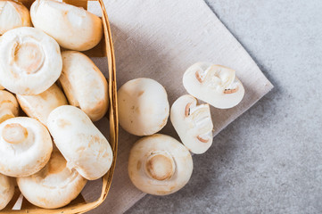 Raw champignon on the table with basket.