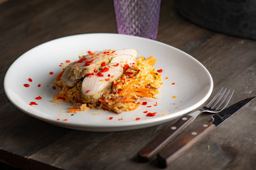 Grilled chicken on fried riced toped with chili..​