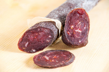 Smoked sousage with pepper on wooden table