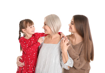 Portrait of beautiful mature woman with daughter and grandchild on white background
