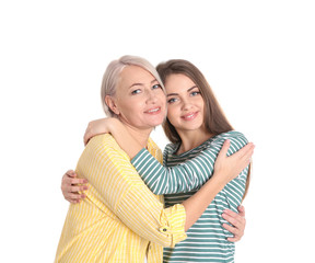 Portrait of young woman with her mature mother on white background