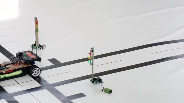 Robotic car model at a crossroads. Classes in robotics for younger students
