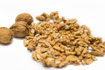 Walnut kernels and whole nutshell closeup macro, isolated on a white background.
