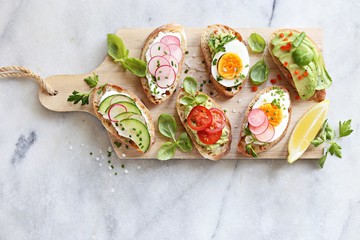 Breakfast sandwich bread with avocado, egg, radishes and tomatoes. Bruschetta or healthy snack ideas - obrazy, fototapety, plakaty