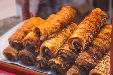 Crispy, Delicious Barbecued Pork Belly ready to serve on table in street food market stall background. Traditional Thai Chinese Asian Street Food, Cuisine, Gourmet, Travel Asia and Culture concept.