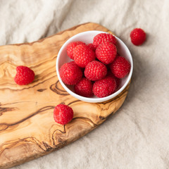 Fresh Raspberries In A Bowl On Linen Background, Top View