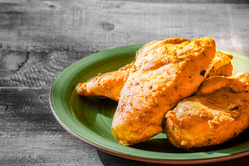 Cooking base kitchen concept. Fried roasted chicken chicken with curry sauce close up.