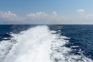 Water trail foaming behind a ferry boat in Aegean Sea. Greece. Vacation concept