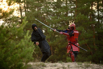 Samurai fight with ninjas on a background of forest and sand