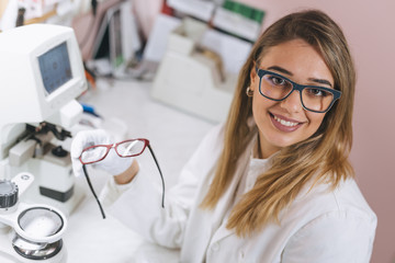 woman ophthalmologist working in optics store