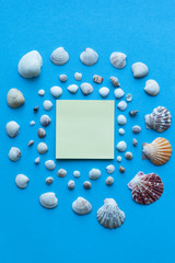Seashells and Sea sand on blue background.