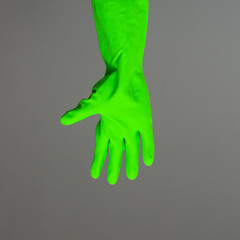 A hand in colorful protective rubber glove. Spring cleaning concept.