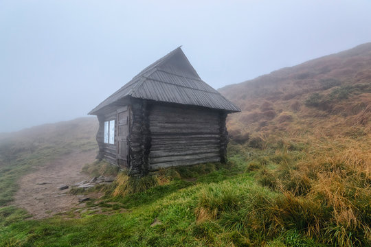 Hut in fog on hill in Chornohora, Ukraine