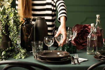 Closeup of housewife preparing table for christmas dinner