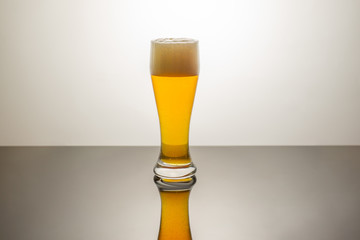 Glass of beer on a white background, closeup