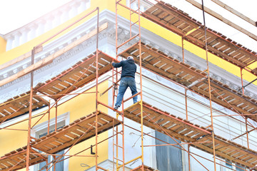 Worker on a building facade restoration
