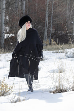 Woman with ushanka walking in snow