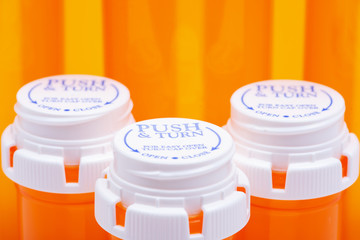 Orange plastic empty prescription containers with Child-Resistant Push&Turn Cap.