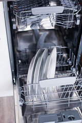 Open dishwasher with clean dishes