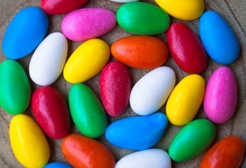 Easter background with colorful glazed candy eggs