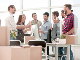business team celebrates the move while standing in the office