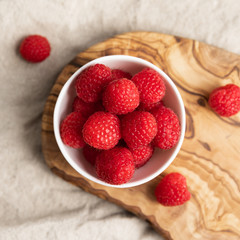 Fresh Raspberries In A Bowl On Linen Background, Top View