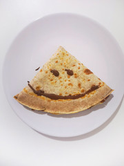 chocolate crepe with smiley face drawn
