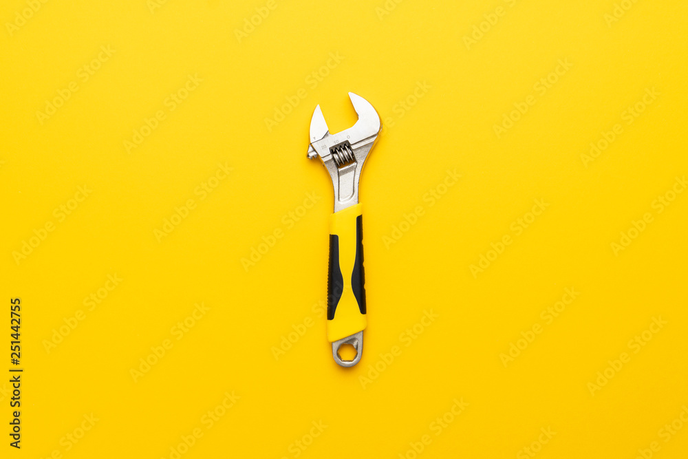 Wall mural adjustable wrench with yellow handle on the yellow background