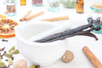 Vanilla in the pounder on white wooden table. Food foto