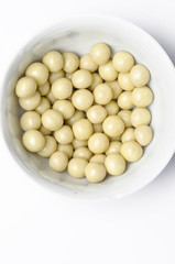 Tasty white chocolate ball in cup isolated on white background